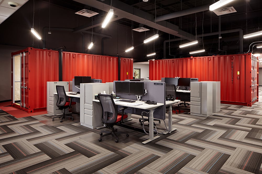 Office area shows how WSKF integrated Kalmar’s brand red and shipping containers for work spaces/functions throughout the office